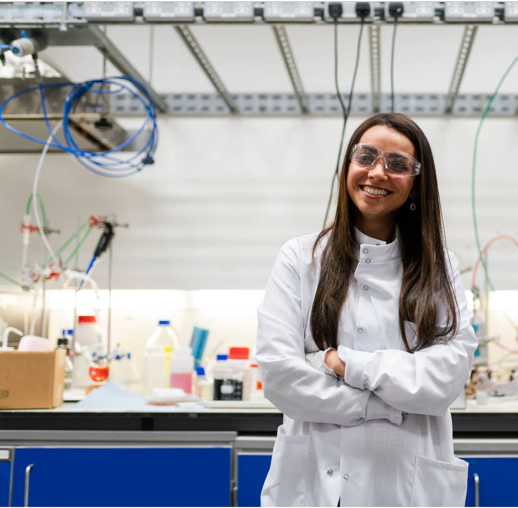 smiling lab manager in white coat + Laboratory equipment