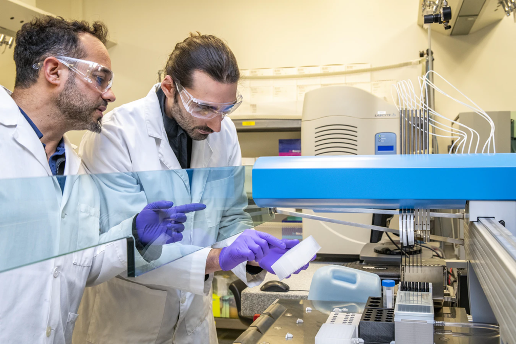 two researchers in lab working with Laboratory equipment